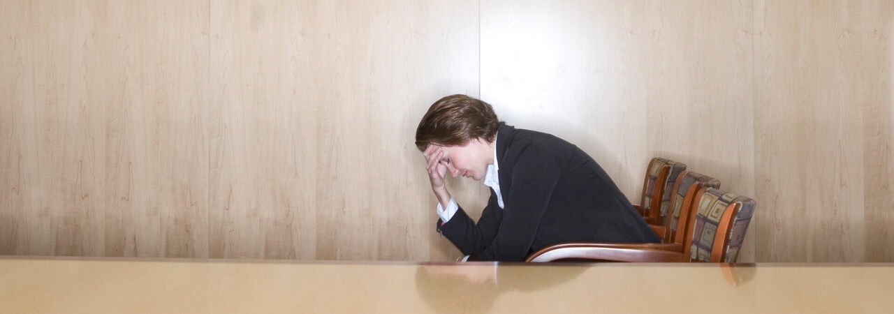 business woman distressed hands on head