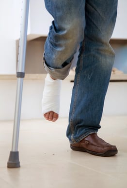 Man with a cast on his leg and crutches